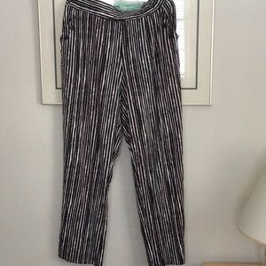 Woman’s flowing striped slacks.
